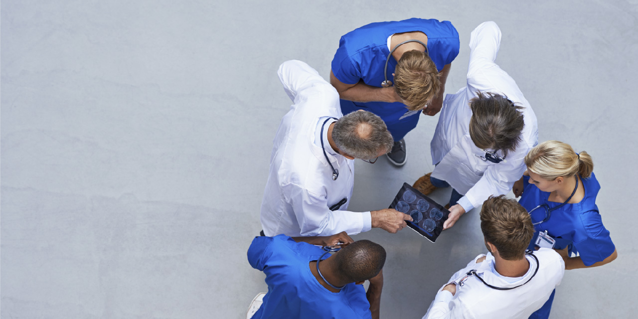 Medical personnel looking at a tablet