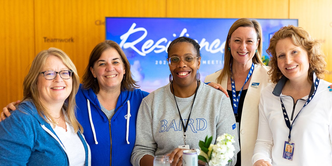 Four Baird Associates posting for a group photo.